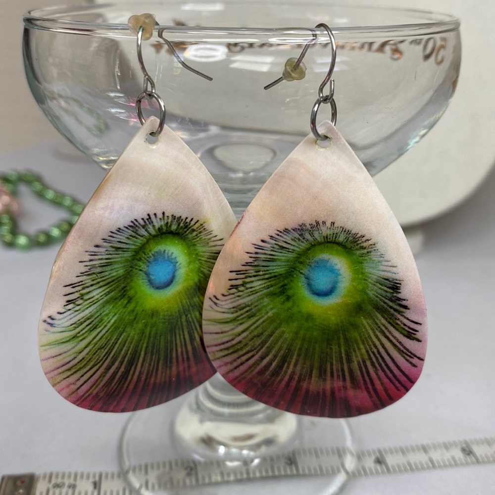 Shell earrings with embossed peacock feather design
